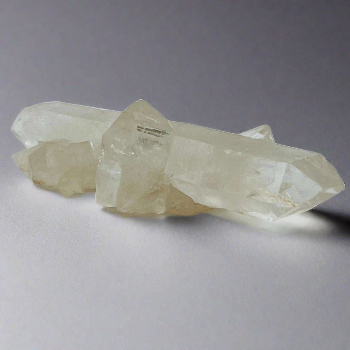 A side view of a Clear Quartz Wand that has mini Clear Quartz clusters coming off of it.