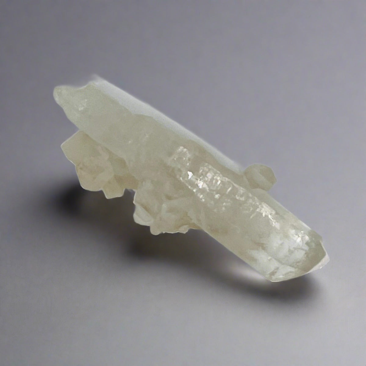 A top view of a Clear Quartz Wand that has mini Clear Quartz clusters coming off of it.