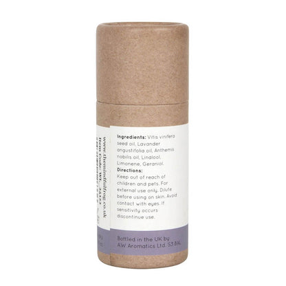 Cardboard essential oil bottle packaging, featuring a white and purple label that states ingredients.