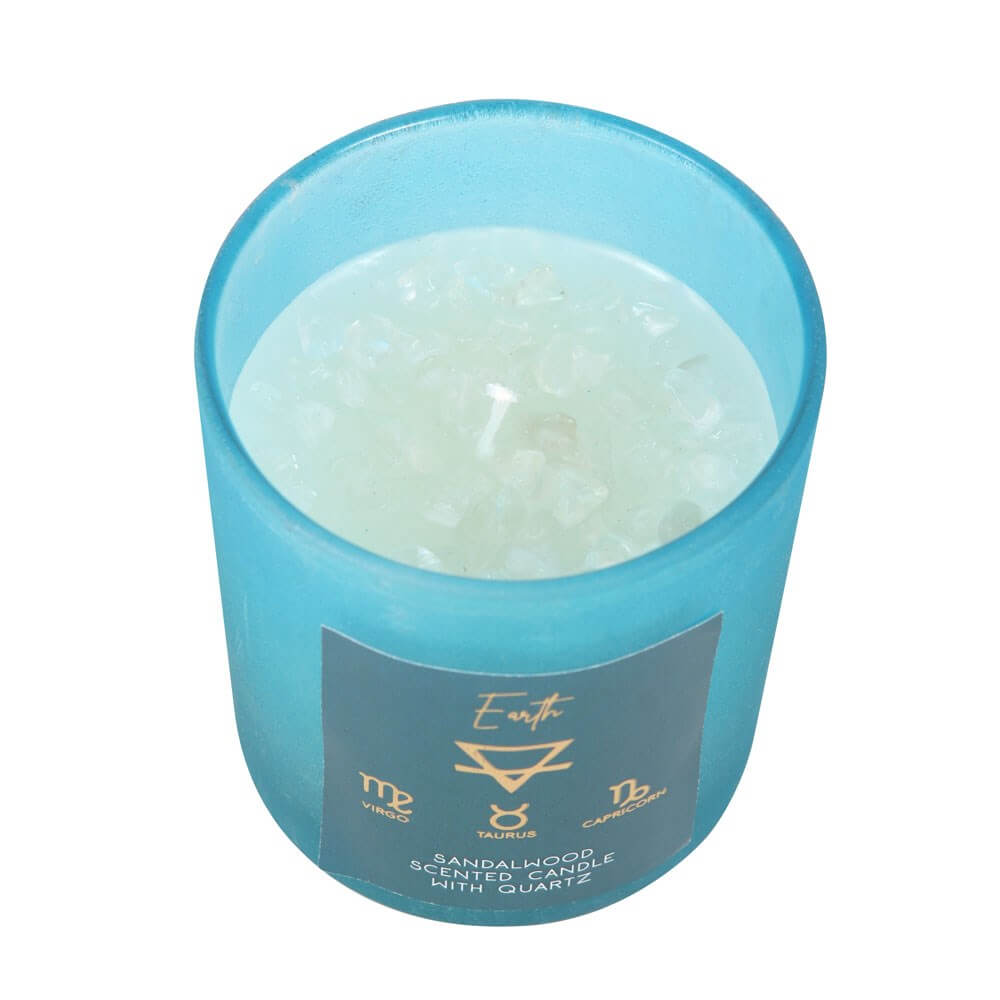 A top view of the Sandalwood scented light blue candle in a jar that has Clear Quartz crystal chips in.