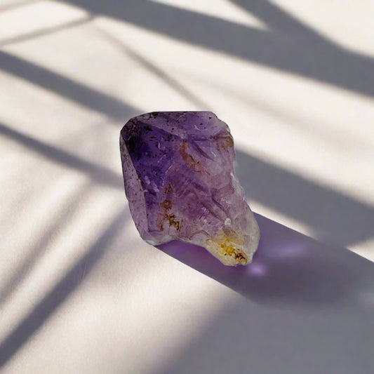 A deep purple rough Amethyst crystal point from another view point.