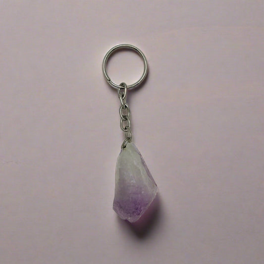 A rough point chunk of purple Amethyst on a silver keychain.